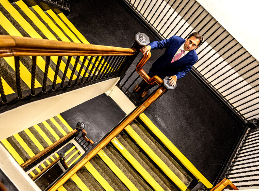Joe Gramando standing on the stairs at the Howland Hughes Building in Waterbury CT, looking up