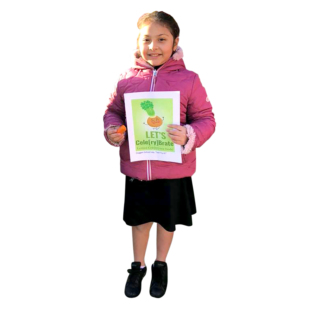 A Waterbury student smiling and holding a healthy eating flyer