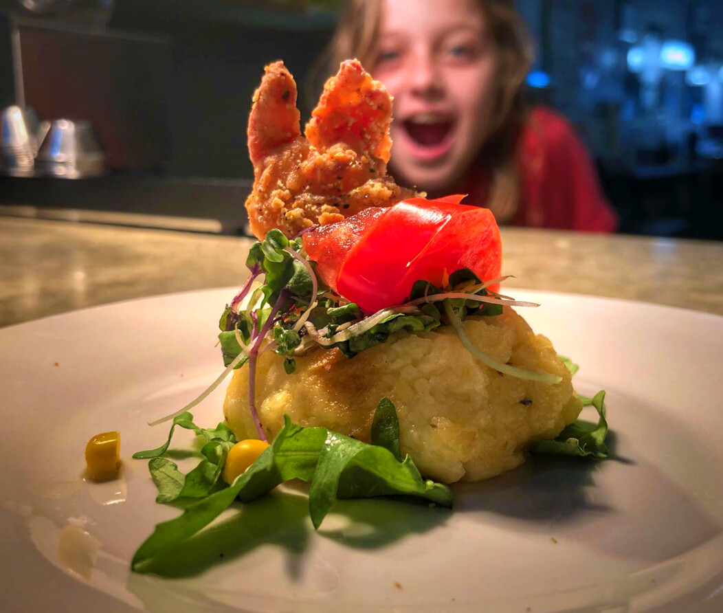 Child looking at elaborately plated dish with excitement at The Art of Yum in Waterbury