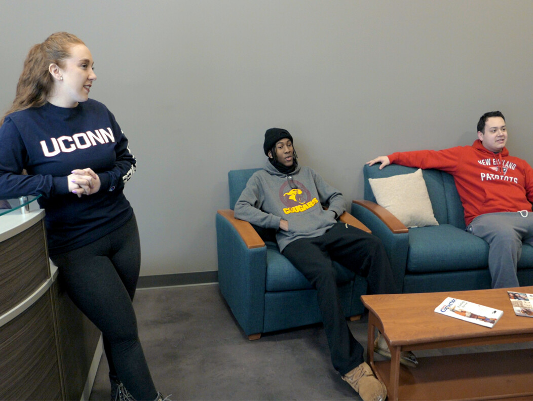 Two UConn Waterbury students lounging at the residence hall at the Brown Building