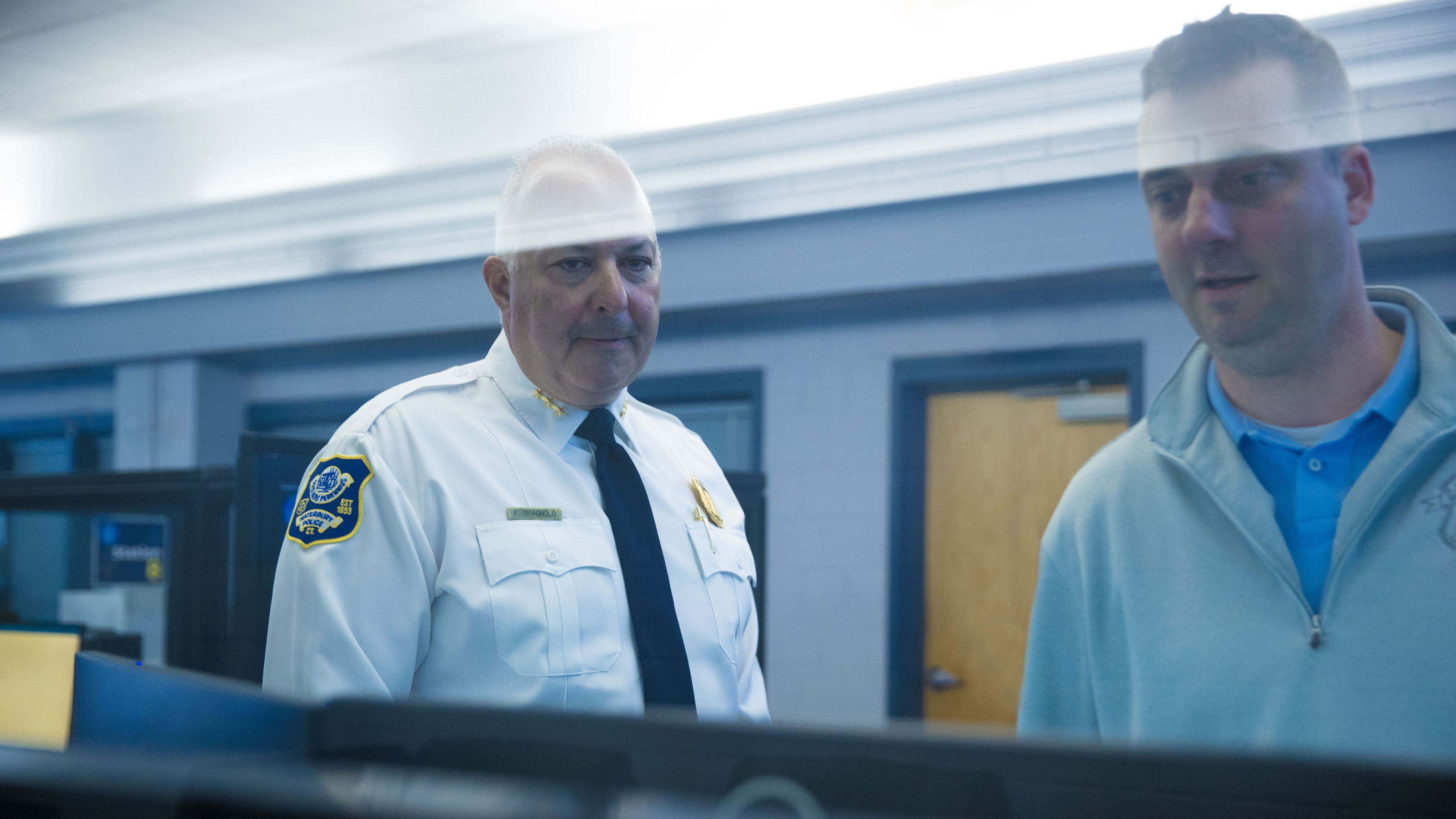 Waterbury, CT Police Chief Fred Spagnolo reviews video screen in the Real Time Crime Center