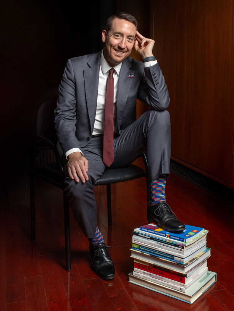 Waterbury, CT Superintendent Darren Schwartz in chair with foot on stack of books
